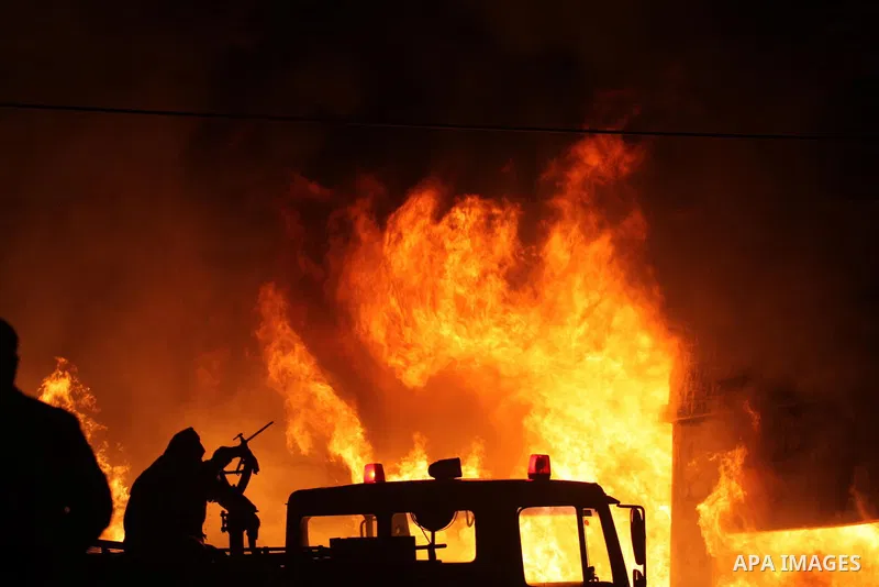 Palestinian civil defense forces try to stop fire burning in carpentry workshop and a factory for plastic materials, in the area of Doha, in Bethlehem on February 12, 2011. Photo by Najeh Hashlamoun