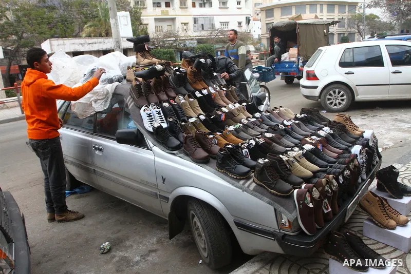 A Palestinian vendor displays shoes at his car in Gaza City on February 13, 2011. Photo by Ashraf Amra