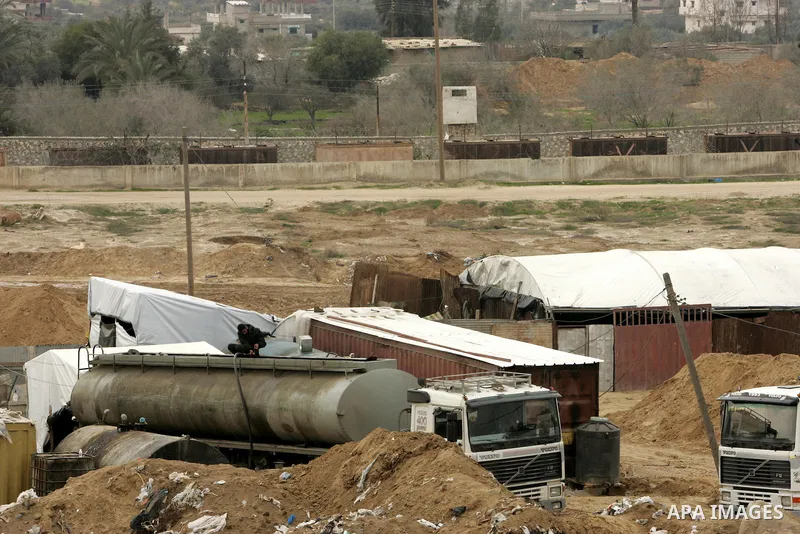 Palestinian trucks load fuel from smuggling tunnels along the Gaza-Egypt border, near the southern Gaza Strip town of Rafah, on February 13, 2011. Israel and Egypt first imposed closures on the Palestinian territory afte...