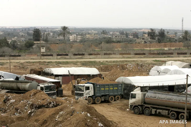 Palestinian trucks load fuel from smuggling tunnels along the Gaza-Egypt border, near the southern Gaza Strip town of Rafah, on February 13, 2011. Israel and Egypt first imposed closures on the Palestinian territory afte...