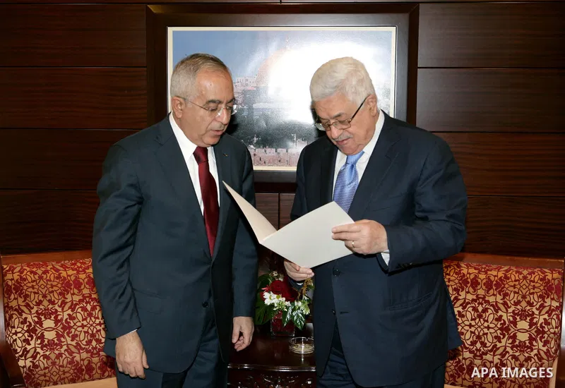 Palestinian Prime Minister Salam Fayyad submits his government's resignation to the Palestinian President Mahmoud Abbas, in the West Bank City of Ramallah on Feb. 14, 2011. Photo by Thaer Ganaim