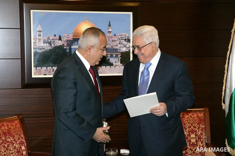 Palestinian Prime Minister Salam Fayyad as he submits his government's resignation to Palestinian President Mahmoud Abbas in Abbas' offices in the West Bank town of Ramallah, 14 February 2011. Abbas asked Fayyad to form...