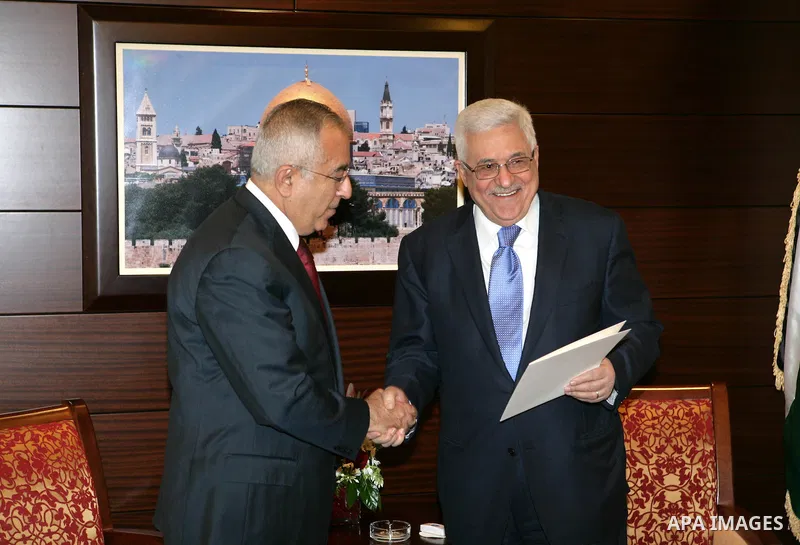 Palestinian Prime Minister Salam Fayyad as he submits his government's resignation to Palestinian President Mahmoud Abbas in Abbas' offices in the West Bank town of Ramallah, 14 February 2011. Abbas asked Fayyad to form...