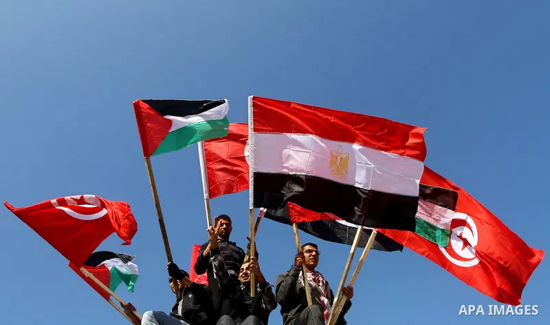 Palestinian supporters of Popular Front for the Liberation of Palestine (PFLP) hold Egypt flag in support of the protesters in Egypt who forced their President Hosni Mubarak to resign, as they march in a rally in Gaza Ci...