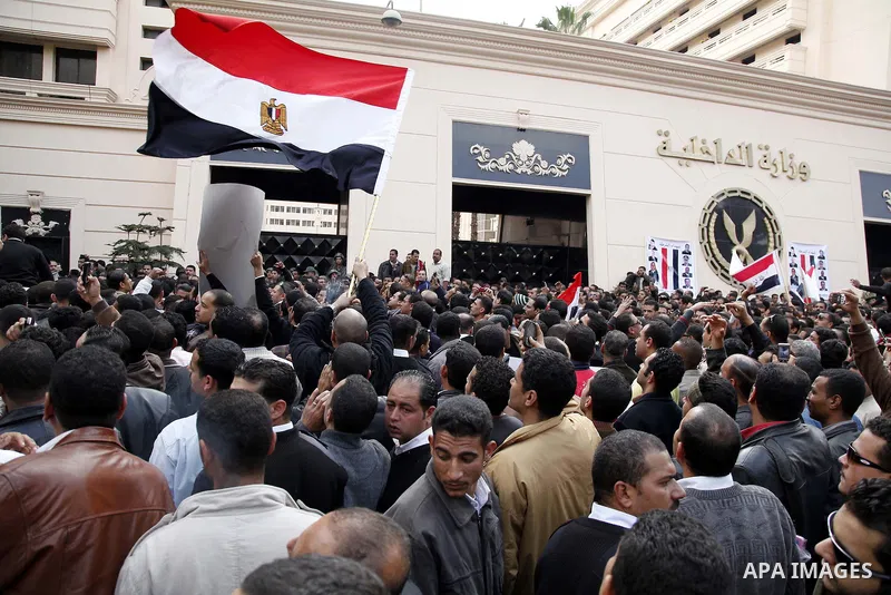 Egyptian police officers and protesters shouts 'The police and the people are one hand', In front of the Ministry of Interior in downtown Cairo, Egypt , Feb. 14, 2011. Egypt's military is taking down the makeshift tents...