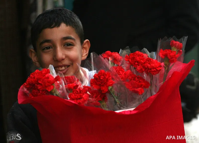 A Palestinian boy sells flower in the Valentine's Day gifts at a shop in the West Bank city of Ramallah February 14, 2011. Photo by Issam Rimawi