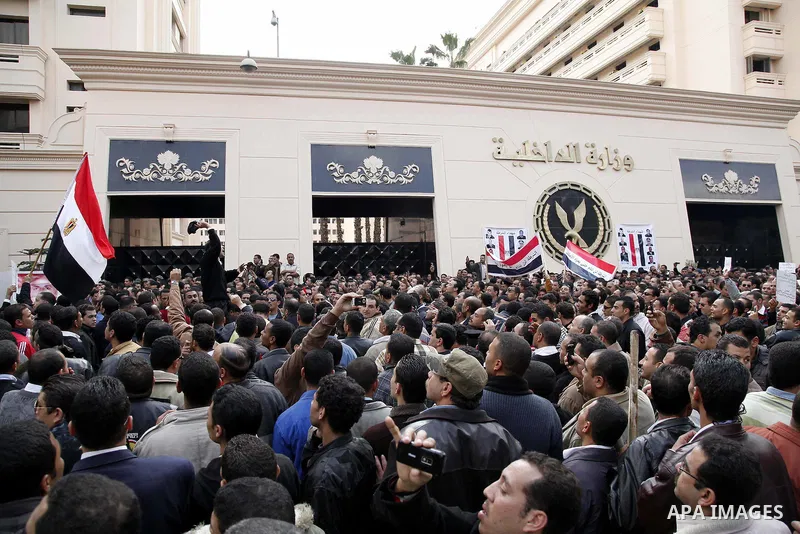 Egyptian police officers and protesters shouts 'The police and the people are one hand', In front of the Ministry of Interior in downtown Cairo, Egypt , Feb. 14, 2011. Egypt's military is taking down the makeshift tents...