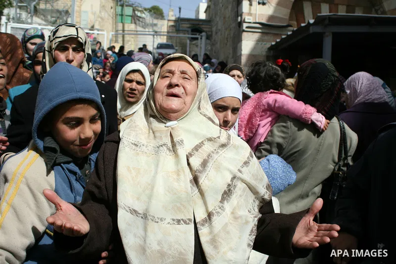Palestinians go to Ibrahimi mosque as they march in a procession to mark the birth anniversary of Islam's prophet Mohammed, in the West Bank city of Hebron Tuesday, Feb. 15, 2011. Muslims celebrate Prophet Mohammed's bir...