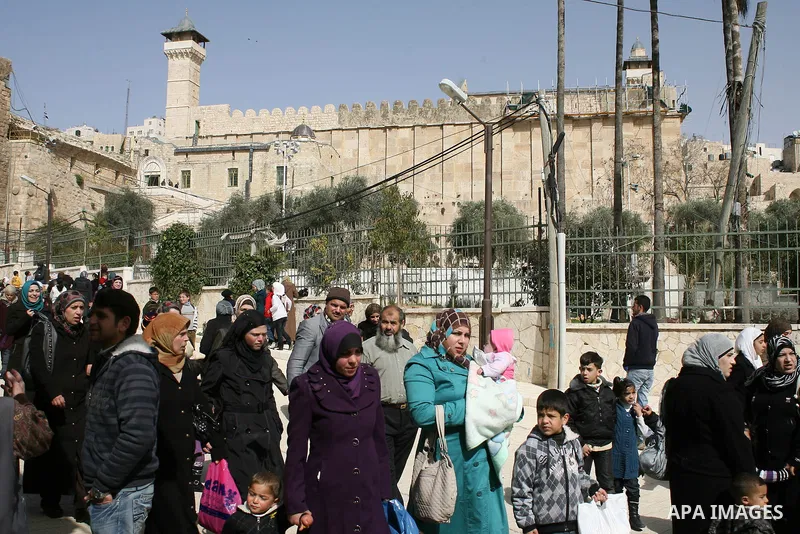 Palestinians go to Ibrahimi mosque as they march in a procession to mark the birth anniversary of Islam's prophet Mohammed, in the West Bank city of Hebron Tuesday, Feb. 15, 2011. Muslims celebrate Prophet Mohammed's bir...