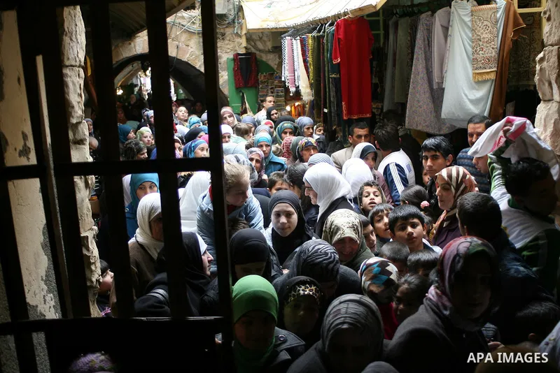 Palestinians go to Ibrahimi mosque as they march in a procession to mark the birth anniversary of Islam's prophet Mohammed, in the West Bank city of Hebron Tuesday, Feb. 15, 2011. Muslims celebrate Prophet Mohammed's bir...