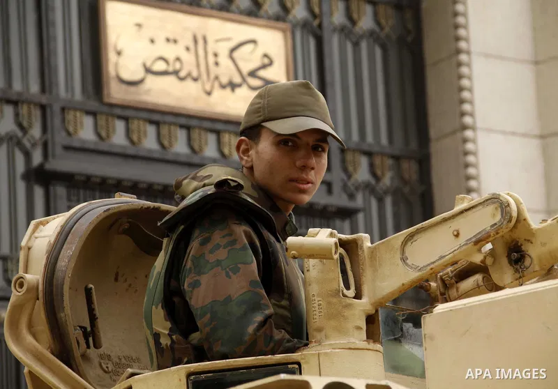 Egyptian soldiers stands guard as protesters take part in a rally calling for release of political prisoners in Cairo, Egypt, Wednesday, Feb. 16, 2011. Photo by Ahmed Asad