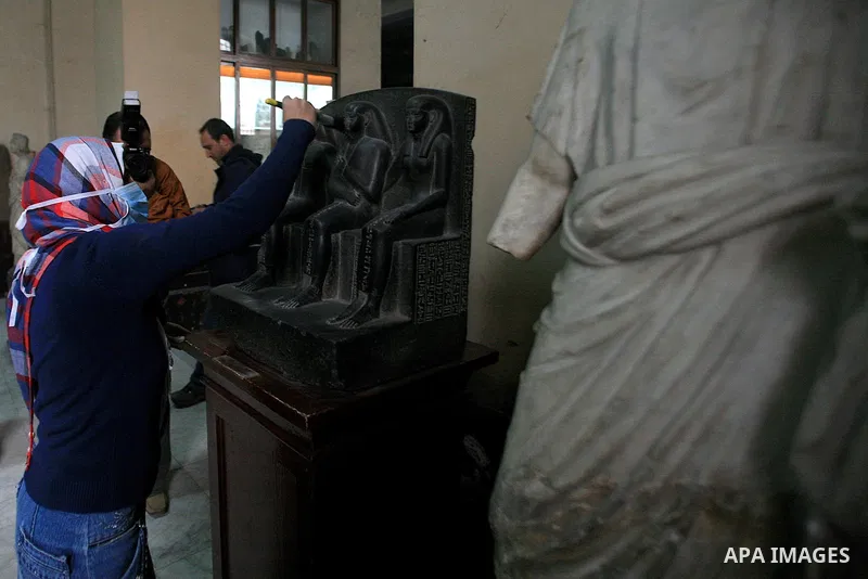 A museum worker cleans in the Egyptian Museum in preparations for its reopening in Cairo, Egypt, Wednesday Feb. 16, 2011. According to Dr. Zahi Hawass, Director for the Supreme Council of Antiquities , thieves entered th...