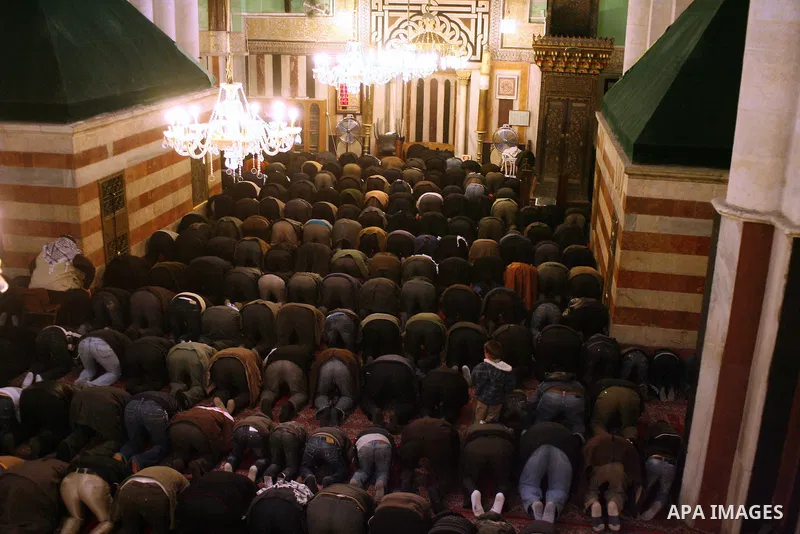 Palestinians take part in Ibrahimi mosque as they march in a procession to mark the birth anniversary of Islam's prophet Mohammed, in the West Bank city of Hebron Tuesday, Feb. 16, 2011. Muslims celebrate Prophet Mohamme...
