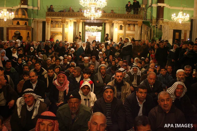 Palestinians take part in Ibrahimi mosque as they march in a procession to mark the birth anniversary of Islam's prophet Mohammed, in the West Bank city of Hebron Tuesday, Feb. 16, 2011. Muslims celebrate Prophet Mohamme...