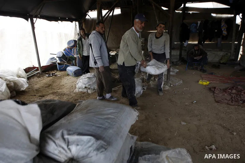Palestinian workers smuggle cement into the Gaza Strip through a tunnel under the Egypt-Gaza border in Rafah, in the southern Gaza Strip on Feb. 16, 2011. Photo by Abed Rahim Khatib