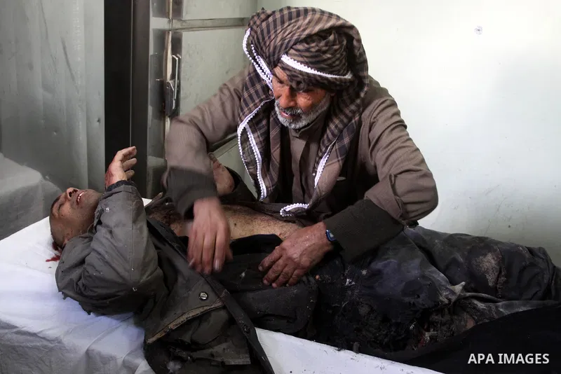 A Palestinian man cleans the body of one of the three killed Palestinians, at the morgue in Kamal Adwan hospital in the town of Beit Lahiya, northern Gaza Strip, on Feb. 17, 2011. Three Palestinian fishermen were slain o...
