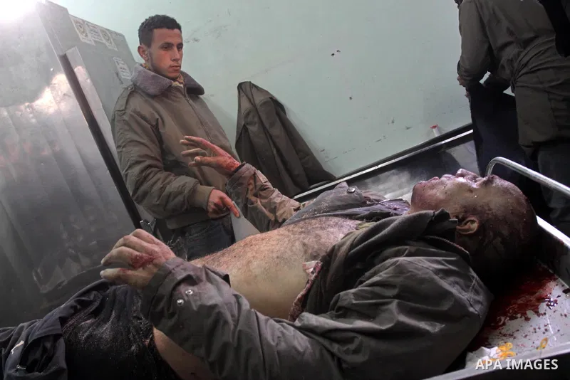 A Palestinian man looks at the body of one of the three killed Palestinians, at the morgue in Kamal Adwan hospital in the town of Beit Lahiya, northern Gaza Strip, on Feb. 17, 2011. Three Palestinian fishermen were slain...