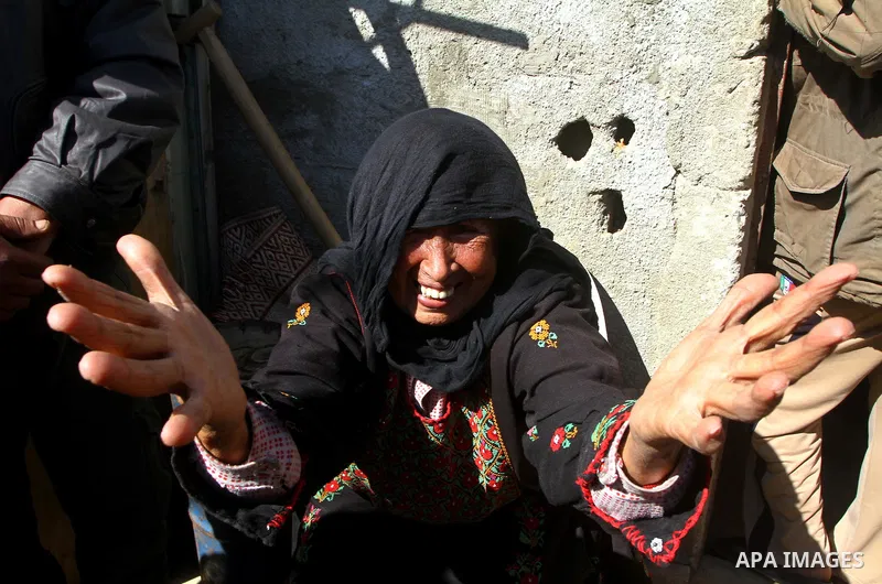 A relative of Jihad Khalaf, 20, one of the three Palestinians who were shot dead by Israeli forces, cries during his funeral in Beit Lahia, northern Gaza Strip, on February 17, 201. The three men were killed overnight by...