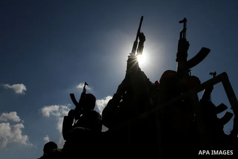 Palestinian militants hold up their weapons as they attend the funeral of three Palestinian men who were shot dead by Israeli forces, in Beit Lahia, northern Gaza Strip, on February 17, 2011. The three men were killed ov...