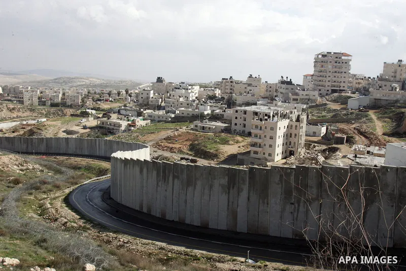 A view of the controversial Israeli separation barrier on the outskirts of Jerusalem on February 17,2011. On the top the Israeli settlement of Pisgat Zeev and on the bottom the refugee camp of Shuafat . Photo by Mahfouz...