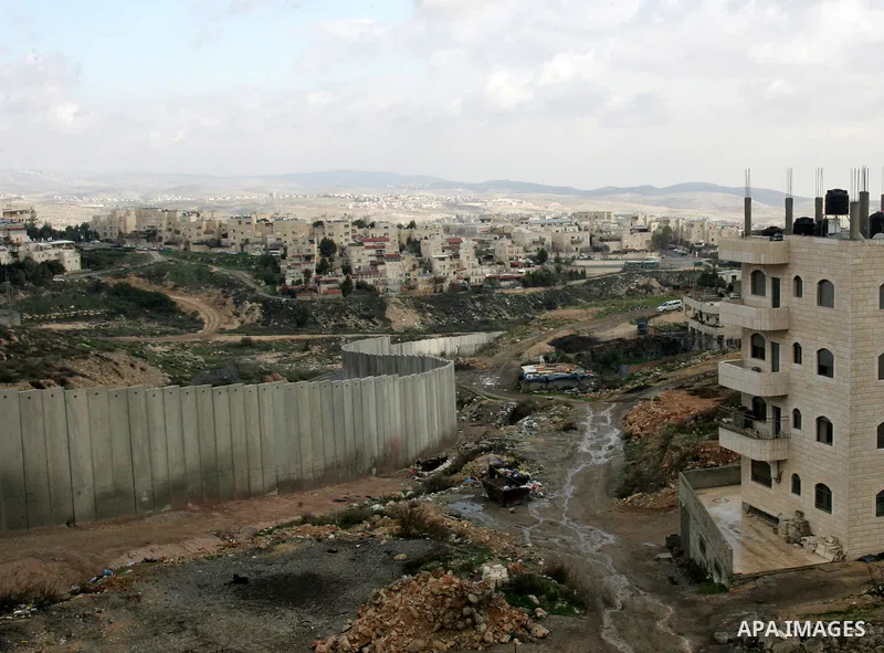 A view of the controversial Israeli separation barrier on the outskirts of Jerusalem on February 17,2011. On the top the Israeli settlement of Pisgat Zeev and on the bottom the refugee camp of Shuafat . Photo by Mahfouz...