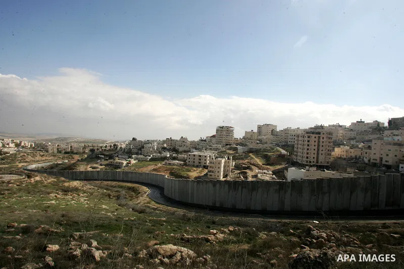 A view of the controversial Israeli separation barrier on the outskirts of Jerusalem on February 17,2011. On the top the Israeli settlement of Pisgat Zeev and on the bottom the refugee camp of Shuafat . Photo by Mahfouz...