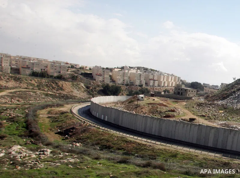A view of the controversial Israeli separation barrier on the outskirts of Jerusalem on February 17,2011. On the left the Israeli settlement of Pisgat Zeev and on the right the refugee camp of Shuafat . Photo by Mahfouz...