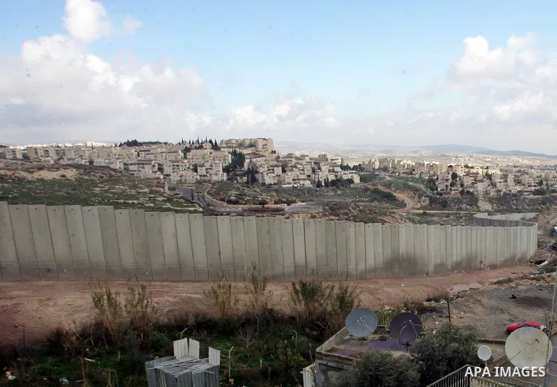A view of the controversial Israeli separation barrier on the outskirts of Jerusalem on February 17,2011. On the top the Israeli settlement of Pisgat Zeev and on the bottom the refugee camp of Shuafat . Photo by Mahfouz...