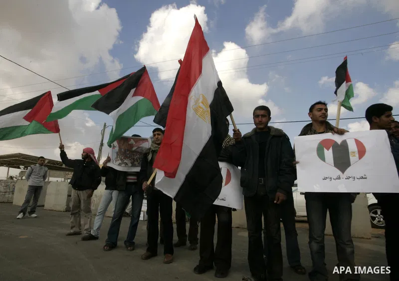 Palestinian youths take part in a march to show support for the Egyptian protesters in Egypt who forced their President Hosni Mubarak to resign, in front of the Rafah border crossing, southern Gaza Strip with Egypt on Fe...