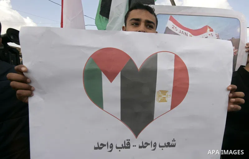 A Palestinian youth takes part in a march to show support for the Egyptian protesters in Egypt who forced their President Hosni Mubarak to resign, in front of the Rafah border crossing, southern Gaza Strip with Egypt on...