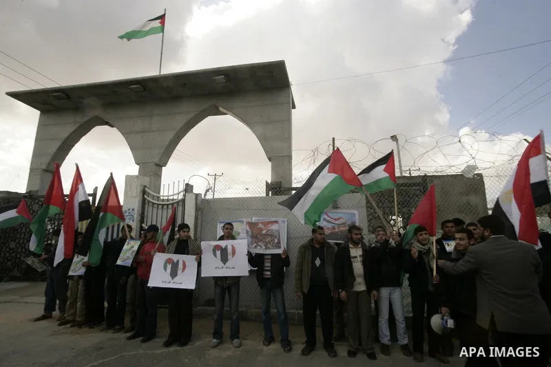 Palestinian youths take part in a march to show support for the Egyptian protesters in Egypt who forced their President Hosni Mubarak to resign, in front of the Rafah border crossing, southern Gaza Strip with Egypt on Fe...