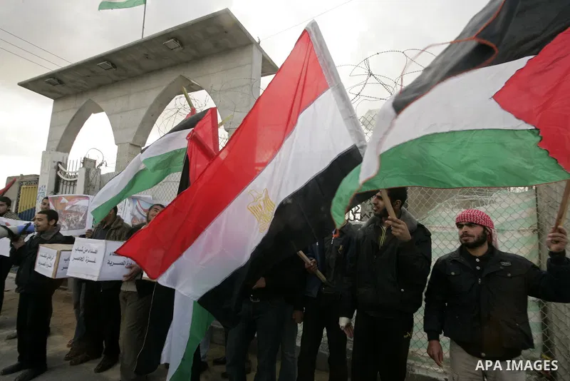 Palestinian youths take part in a march to show support for the Egyptian protesters in Egypt who forced their President Hosni Mubarak to resign, in front of the Rafah border crossing, southern Gaza Strip with Egypt on Fe...