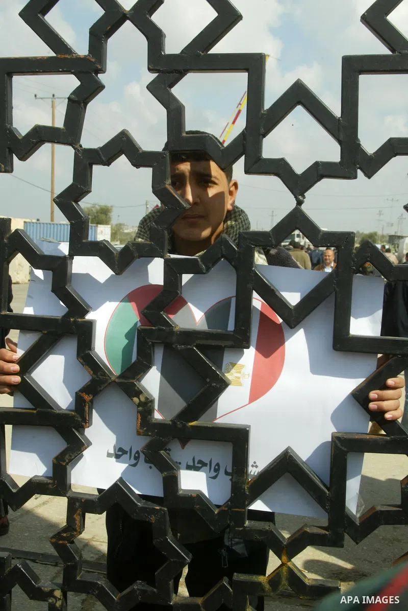 A Palestinian youth takes part in a march to show support for the Egyptian protesters in Egypt who forced their President Hosni Mubarak to resign, in front of the Rafah border crossing, southern Gaza Strip with Egypt on...