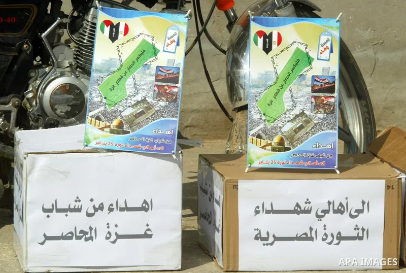 Donate funds are seen during a march to show support for the Egyptian protesters in Egypt who forced their President Hosni Mubarak to resign, in front of the Rafah border crossing, southern Gaza Strip with Egypt on Febru...
