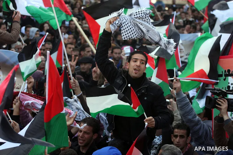 Palestinians take part in a rally calling for ending the Palestinian division, in the West Bank city of Ramallah on Feb. 17, 2011. More than 3000 protesters call for free elections and the reconciliation between the two...