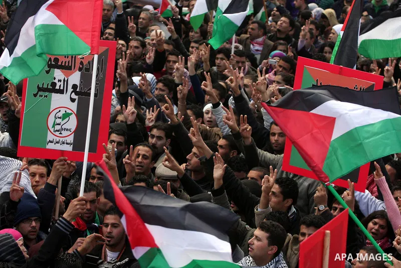 Palestinians take part in a rally calling for ending the Palestinian division, in the West Bank city of Ramallah on Feb. 17, 2011. More than 3000 protesters call for free elections and the reconciliation between the two...