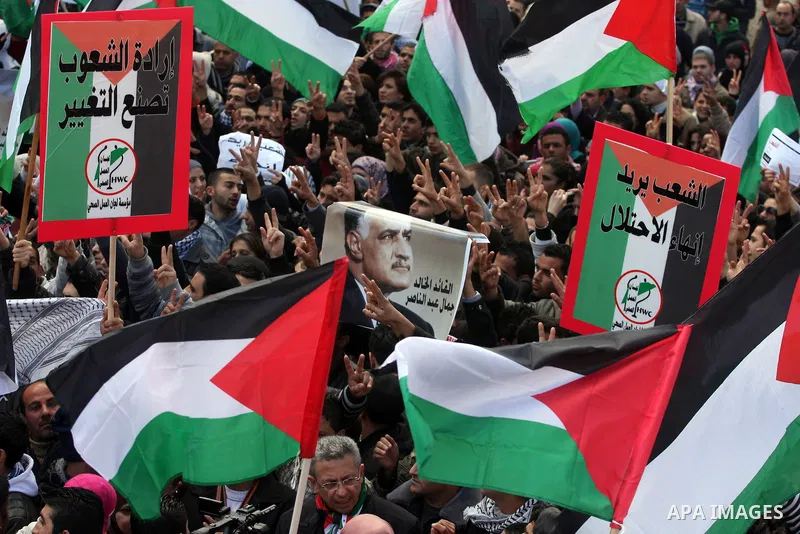 Palestinians take part in a rally calling for ending the Palestinian division, in the West Bank city of Ramallah on Feb. 17, 2011. More than 3000 protesters call for free elections and the reconciliation between the two...