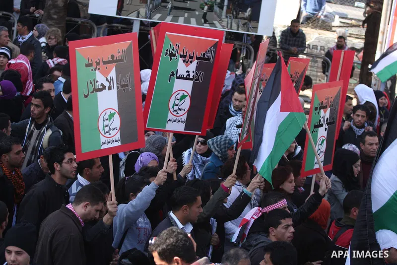Palestinians take part in a rally calling for ending the Palestinian division, in the West Bank city of Ramallah on Feb. 17, 2011. More than 3000 protesters call for free elections and the reconciliation between the two...