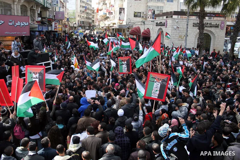 Palestinians take part in a rally calling for ending the Palestinian division, in the West Bank city of Ramallah on Feb. 17, 2011. More than 3000 protesters call for free elections and the reconciliation between the two...