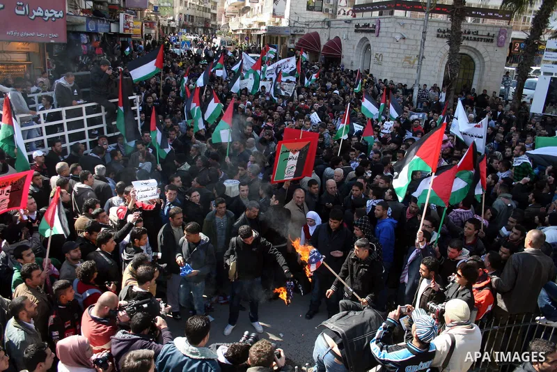 Palestinians take part in a rally calling for ending the Palestinian division, in the West Bank city of Ramallah on Feb. 17, 2011. More than 3000 protesters call for free elections and the reconciliation between the two...