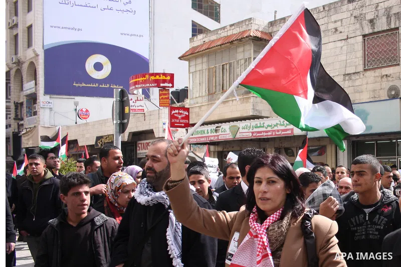 Palestinians take part in a rally calling for ending the Palestinian division, in the West Bank city of Ramallah on Feb. 17, 2011. More than 3000 protesters call for free elections and the reconciliation between the two...
