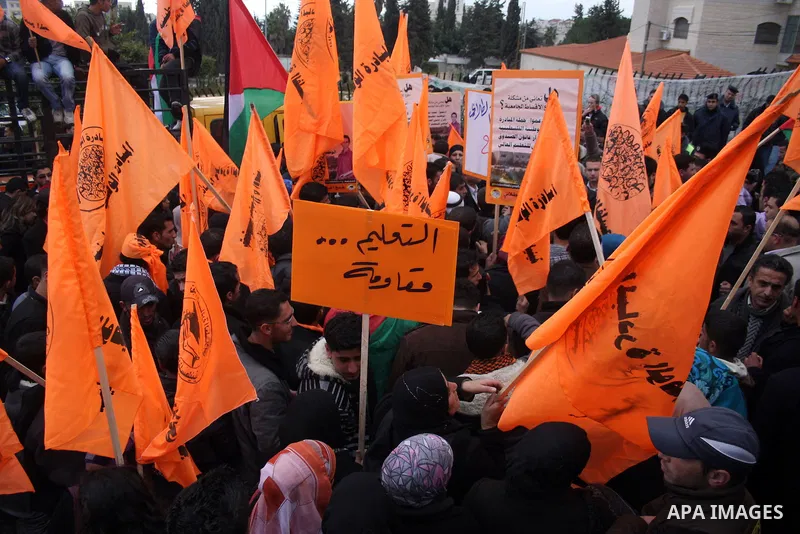 Palestinian National Initiative supporters take part in a demonstration to demand the adoption of "Law of the National Fund for Higher Education" in front of the prime minister building in the West Bank city of Ramallah...