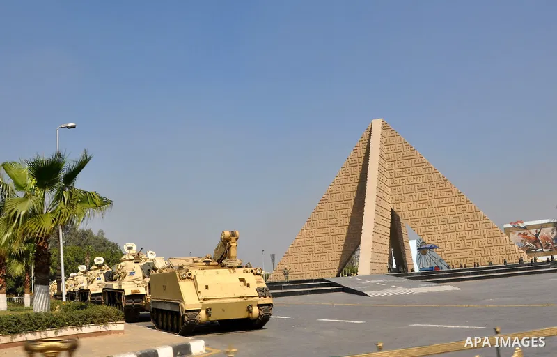 Armored vehicles are seen in front of the memorial stone in Cairo, Egypt on Feb 17,2011. Mubarak's departure set off a chain reaction around the Middle East, with anti-government demonstrations reported Wednesday in Liby...