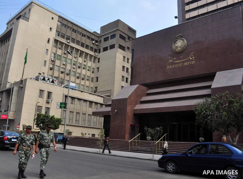 Egyptian soldiers walk in front of an Egyptian bank in Cairo, Egypt on Feb 17,2011. Mubarak's departure set off a chain reaction around the Middle East, with anti-government demonstrations reported Wednesday in Libya, Ba...