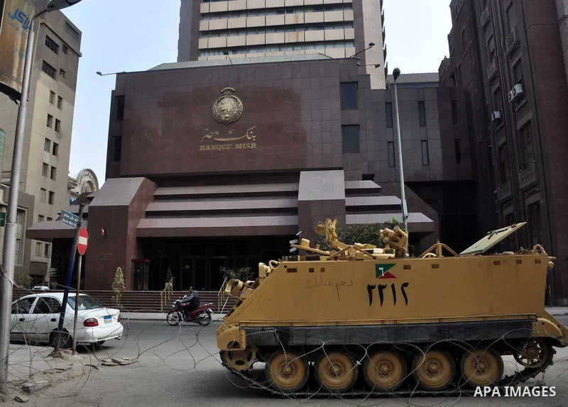 Armored vehicles are seen in front of an Egyptian bank in Cairo, Egypt on Feb 17,2011. Mubarak's departure set off a chain reaction around the Middle East, with anti-government demonstrations reported Wednesday in Libya,...