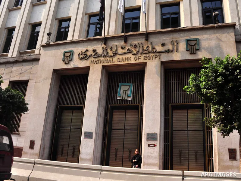 Egyptians walk in front of an Egyptian bank in Cairo, Egypt on Feb 17,2011. Mubarak's departure set off a chain reaction around the Middle East, with anti-government demonstrations reported Wednesday in Libya, Bahrain, J...
