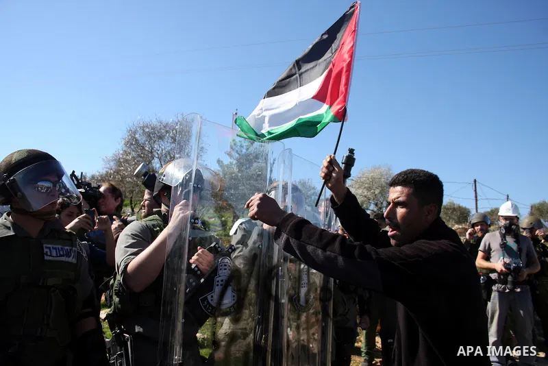 Israeli soldiers scuffle with Palestinian protesters during the weekly demonstration against Israel's separation barrier in the West Bank village of Bilin near Ramallah, Friday, Feb. 18, 2011. Photo by Issam Rimawi