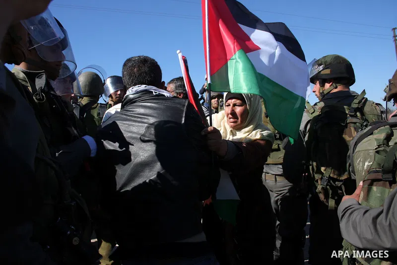 Israeli soldiers scuffle with Palestinian protesters during the weekly demonstration against Israel's separation barrier in the West Bank village of Bilin near Ramallah, Friday, Feb. 18, 2011. Photo by Issam Rimawi
