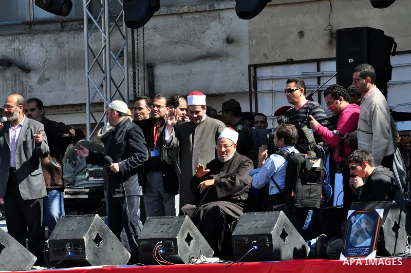 Egyptian cleric Sheik Youssef el-Qaradawi leads Friday prayers in Tahrir Square in Cairo, Egypt, Friday Feb. 18, 2011. Tens of thousands of flag-waving Egyptians packed into Tahrir Square for a day of prayer and celebrat...