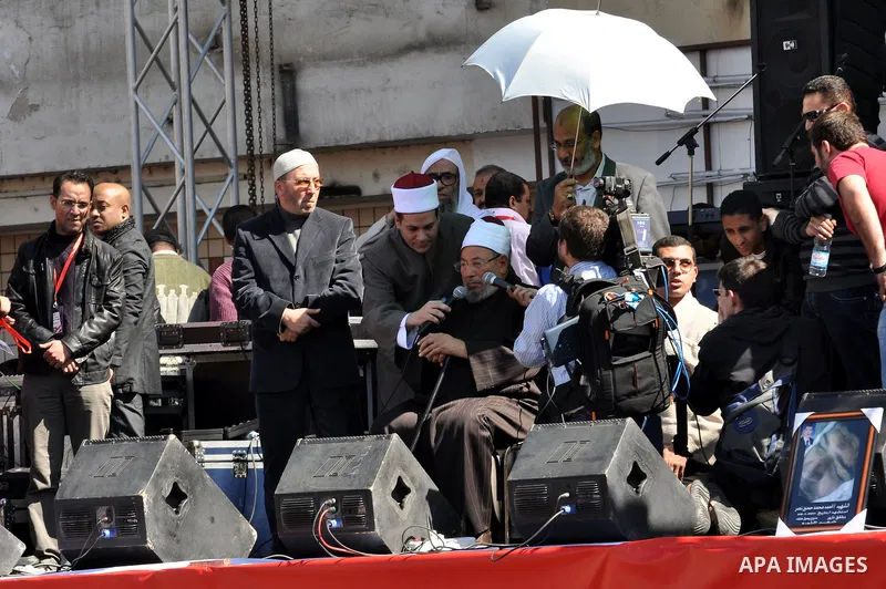 Egyptian cleric Sheik Youssef el-Qaradawi leads Friday prayers in Tahrir Square in Cairo, Egypt, Friday Feb. 18, 2011. Tens of thousands of flag-waving Egyptians packed into Tahrir Square for a day of prayer and celebrat...